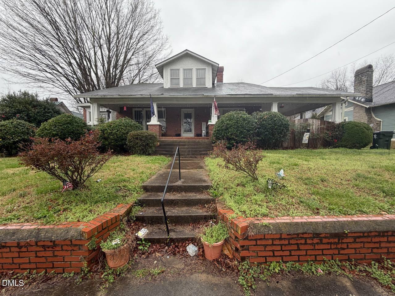 414 Raleigh Road Oxford, NC 27565 - Photo 1 of 24 a front view of a house with a yard table and chairs