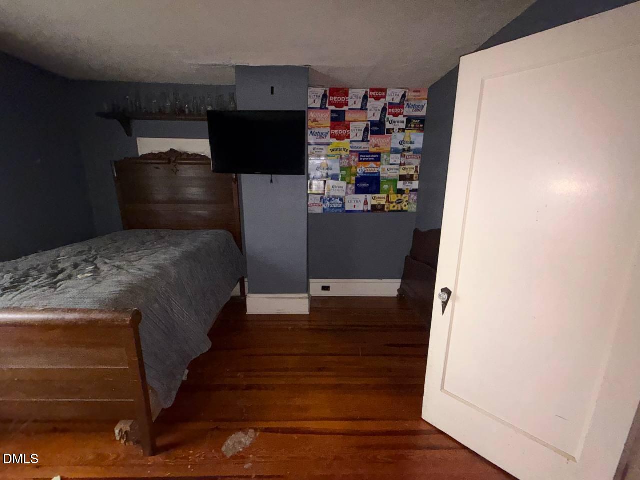 414 Raleigh Road Oxford, NC 27565 - Photo 6 of 24 a bedroom with a bed and a refrigerator