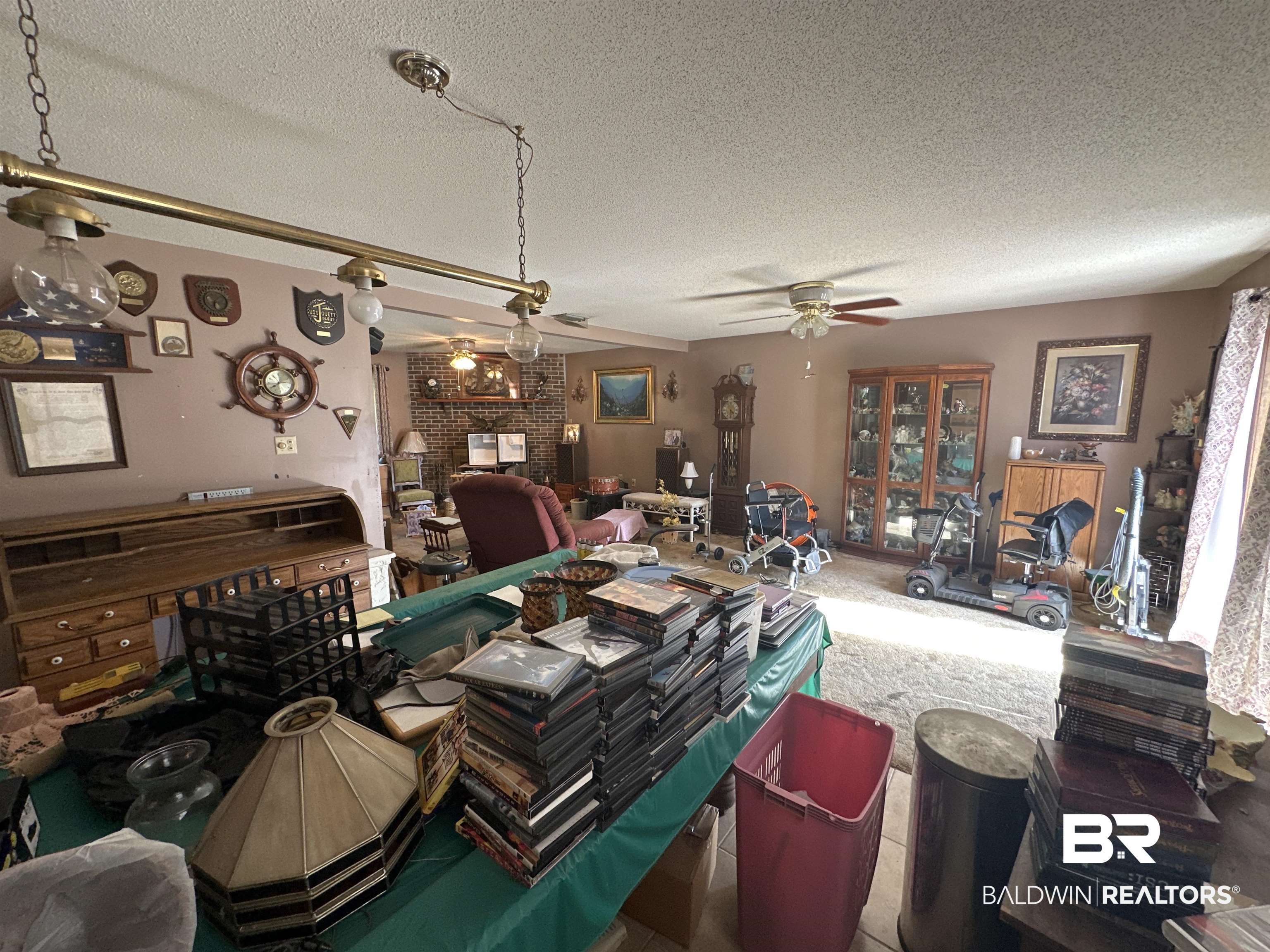 9520 C Four Mile Road Irvington, AL 36544 - Photo 8 of 32 Dining space with ceiling fan, a fireplace, and a textured ceiling
