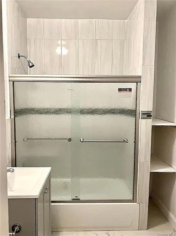 9 Adler Place Brooklyn, NY 11208 - Photo 14 of 19 a bathroom with a bathtub and a shower