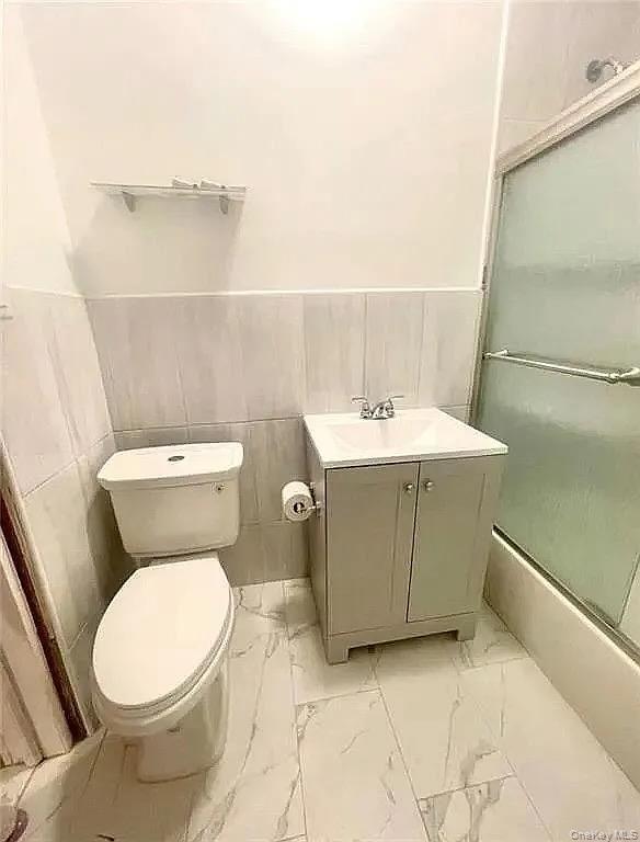 9 Adler Place Brooklyn, NY 11208 - Photo 15 of 19 a bathroom with a toilet sink and mirror