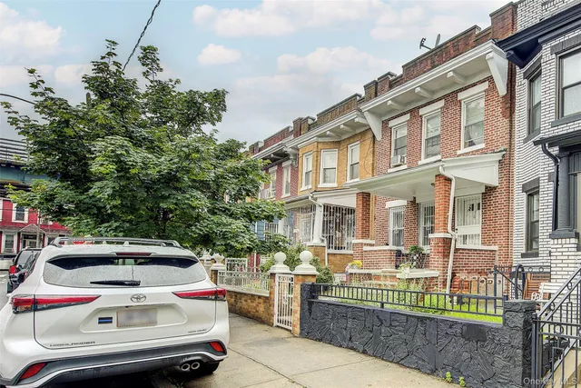 a front view of a house with a garden and plants