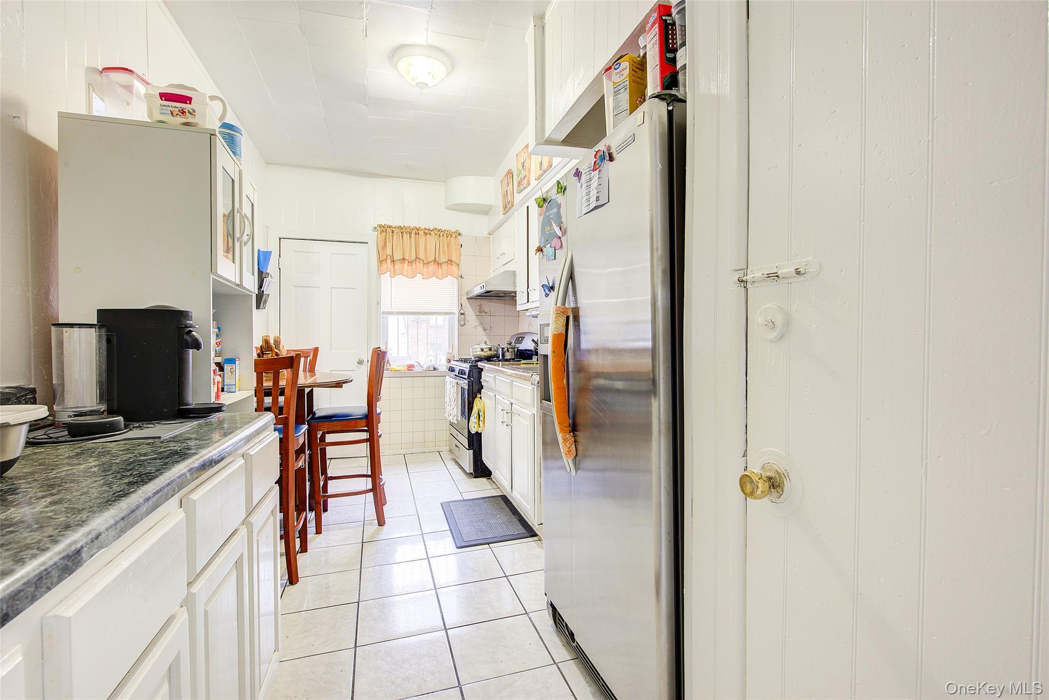9 Adler Place Brooklyn, NY 11208 - Photo 10 of 19 a bathroom with a granite countertop sink a mirror and shower