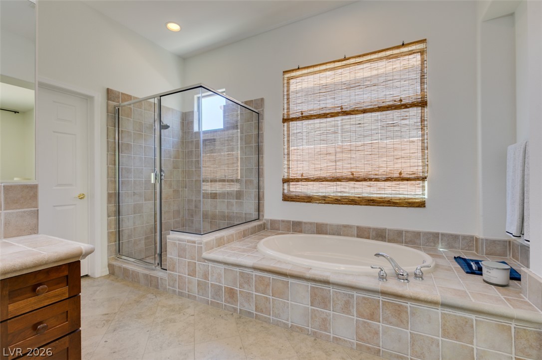 8 Kennesaw Road Henderson, NV 89052 - Photo 34 of 44 Indulge in a primary bathroom featuring a generous soaking tub and a spacious, tiled walk-in shower.