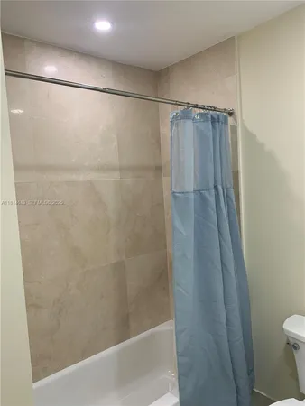 a bathroom with a shower and a toilet
