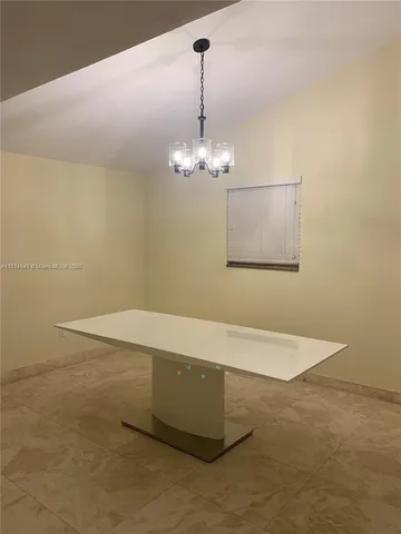 a dining room with a granite top table and chairs