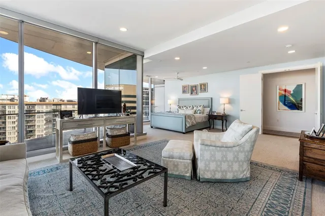 a living room with furniture and large windows