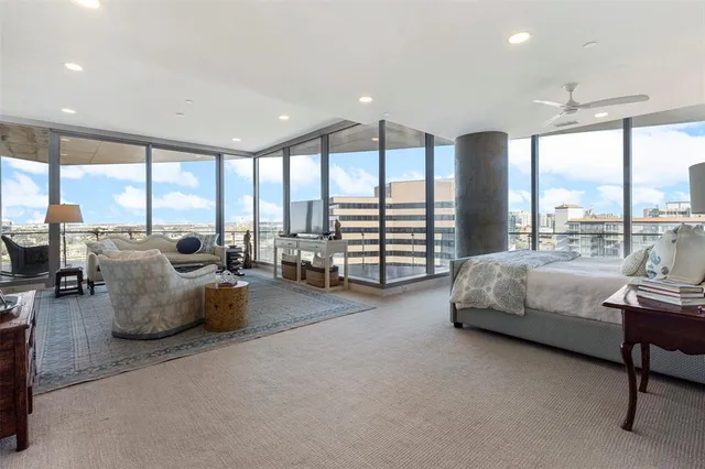 a spacious bedroom with a bed and a lamp