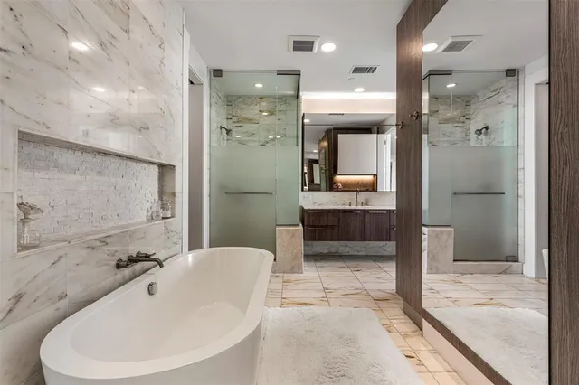 a bathroom with a sink a large mirror and a shower