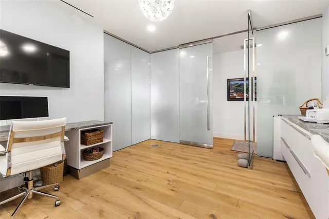 a bathroom with a granite countertop sink mirror vanity and toilet