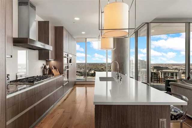 a kitchen with stainless steel appliances granite countertop a sink a stove and a refrigerator