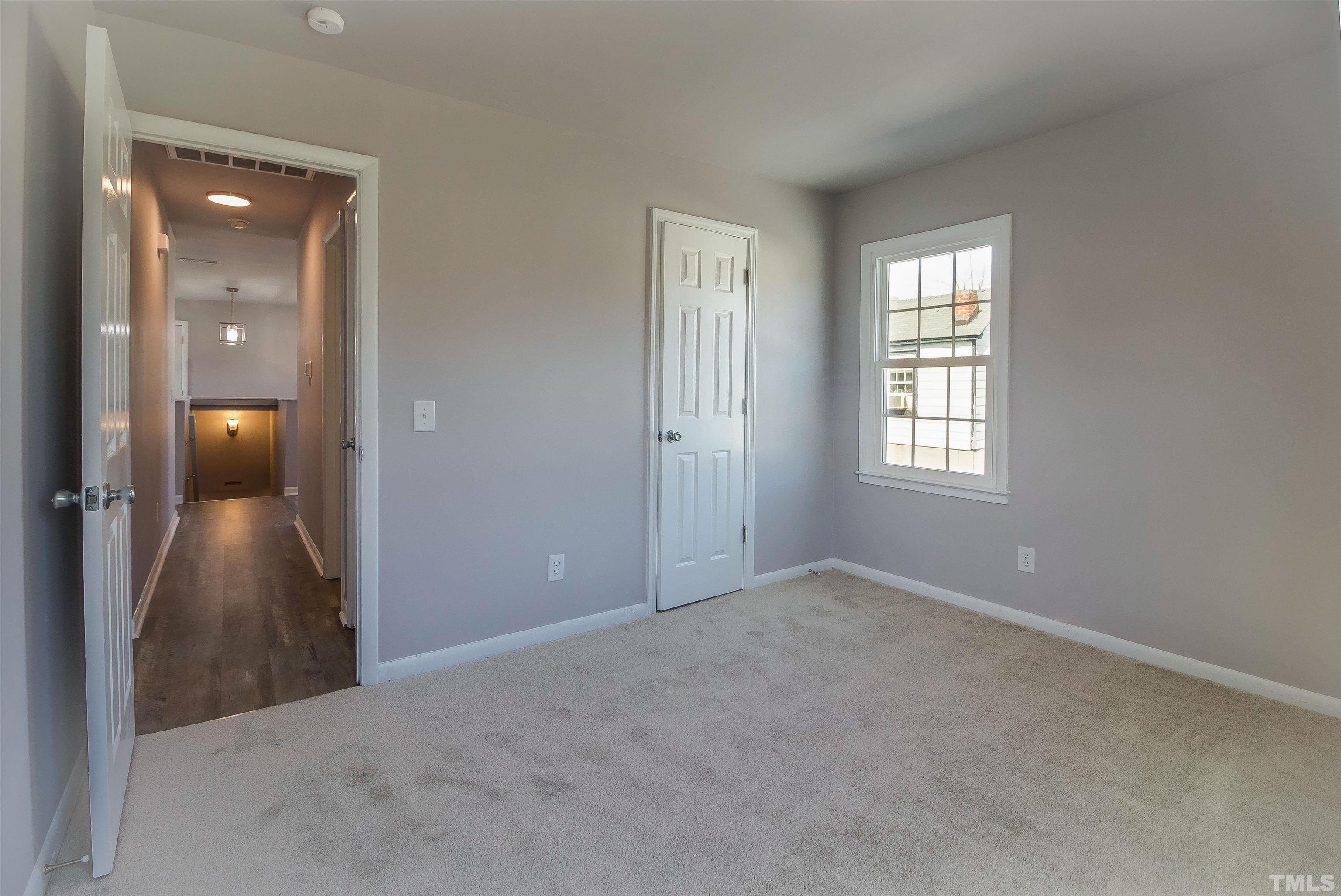 430 South Foushee Street Roxboro, NC 27573 - Photo 17 of 32 an empty room that has a window and wooden floor
