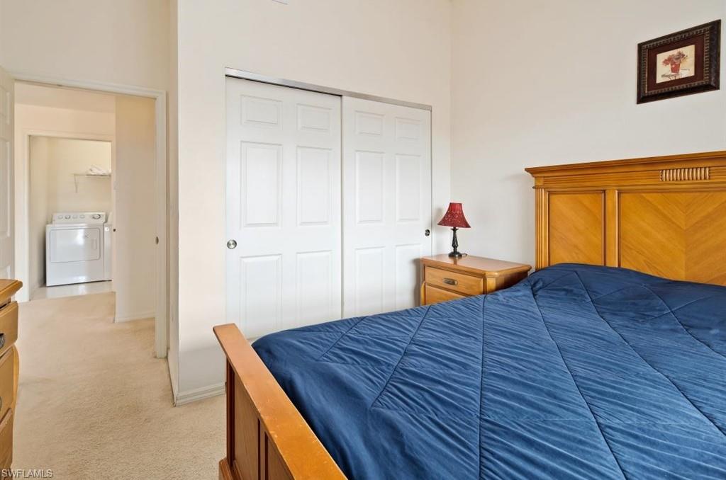 4510 Botanical Pl Circle, Unit 402 Naples, FL 34112 - Photo 12 of 15 a bedroom with a bed and a dresser