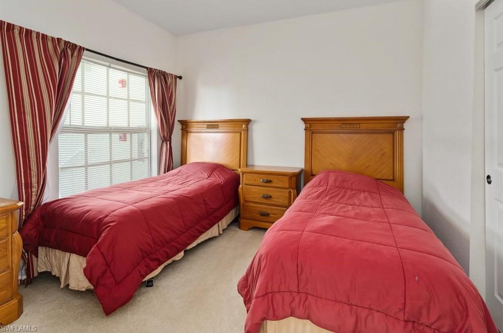 4510 Botanical Pl Circle, Unit 402 Naples, FL 34112 - Photo 13 of 15 a bedroom with a bed and window