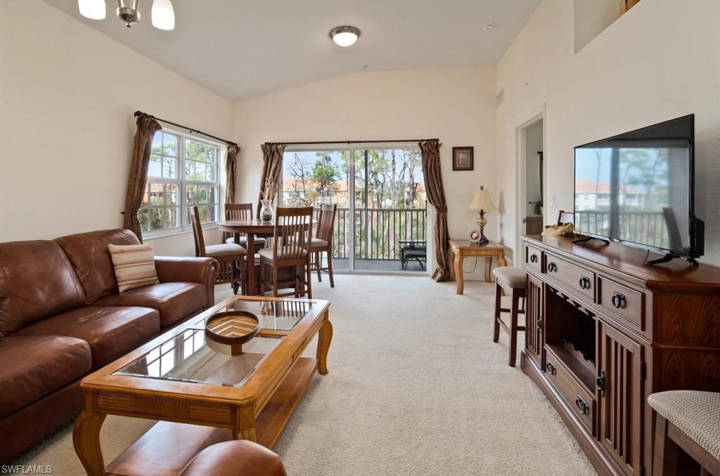 4510 Botanical Pl Circle, Unit 402 Naples, FL 34112 - Photo 3 of 15 a living room with furniture flat screen tv and a large window