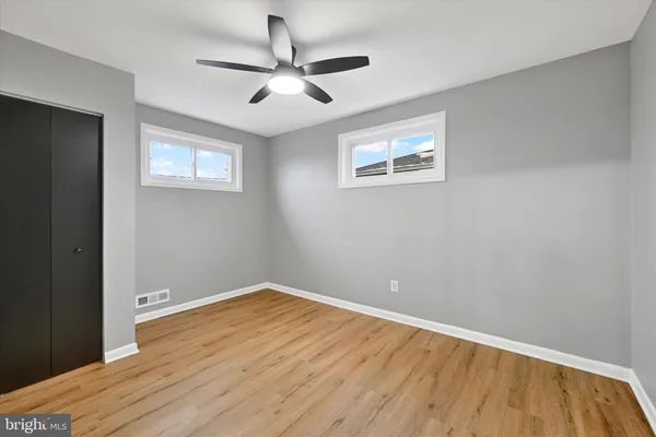 a view of empty room with wooden floor