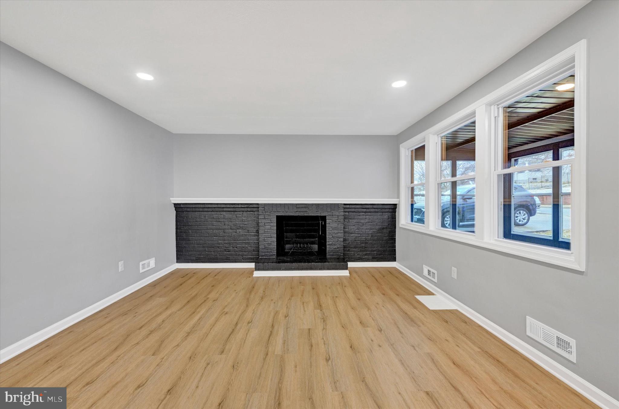 1214 South 48th Street Baltimore, MD 21222 - Photo 17 of 38 a view of an empty room with a fireplace and a window