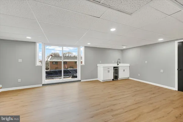a view of a big room with wooden cabinet and windows