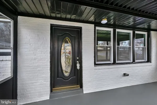 a view of a door and brick walls