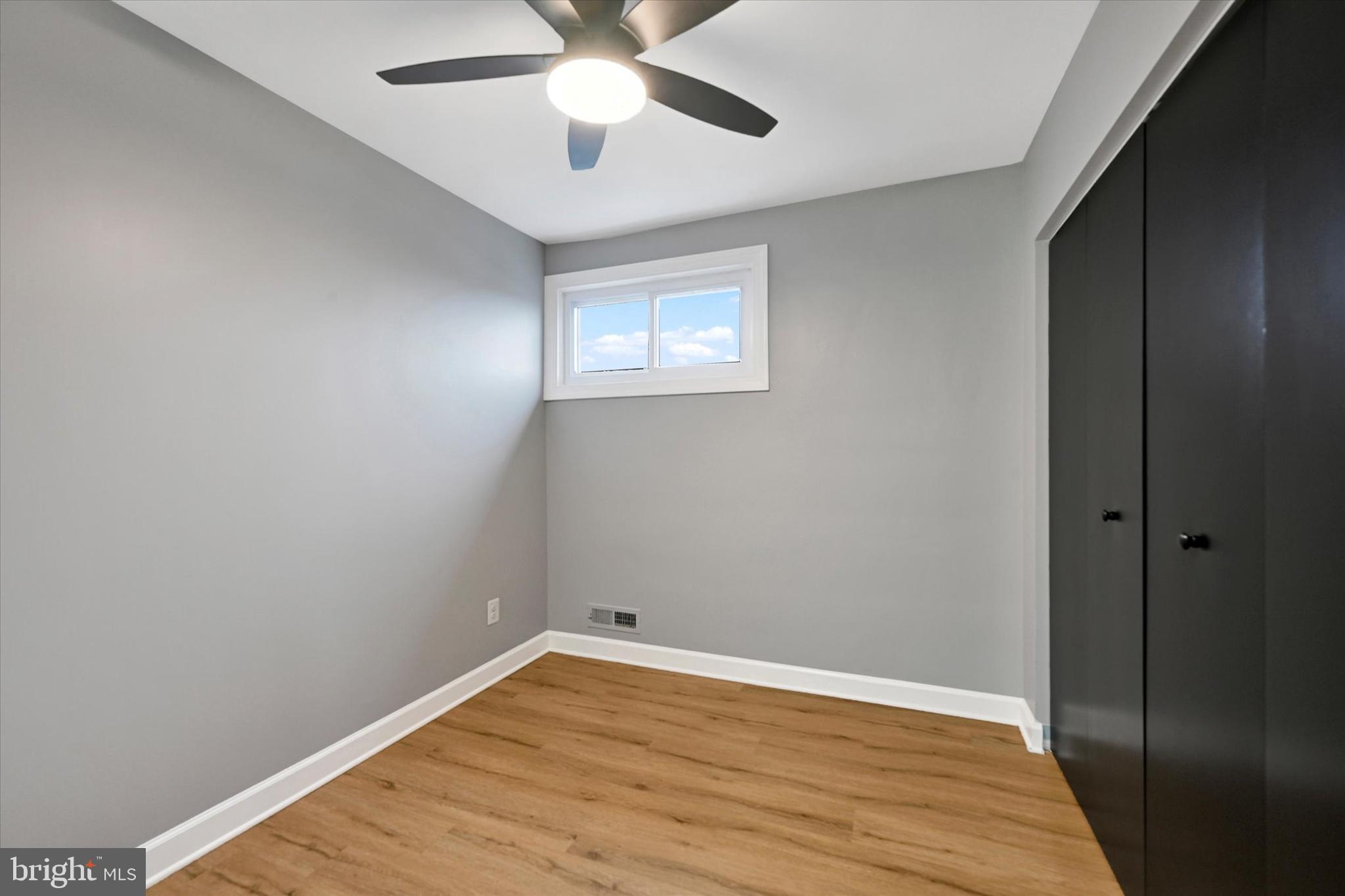 1214 South 48th Street Baltimore, MD 21222 - Photo 21 of 38 an empty room with wooden floor and windows