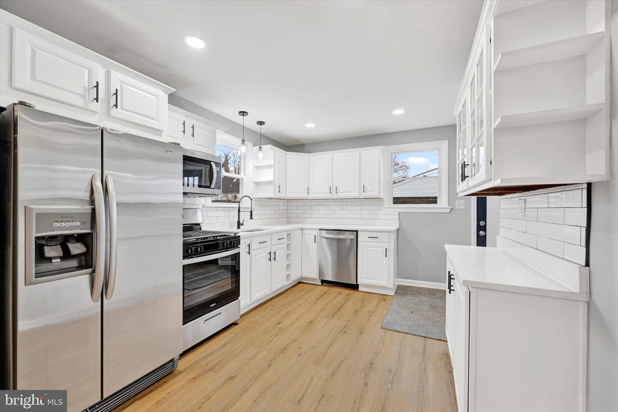 1214 South 48th Street Baltimore, MD 21222 - Photo 26 of 38 a kitchen with stainless steel appliances a refrigerator sink and cabinets