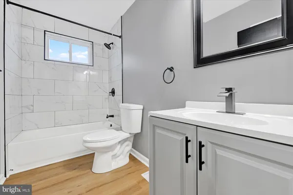 a bathroom with a sink toilet a mirror and shower