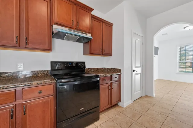 a kitchen with stainless steel appliances granite countertop a sink stove and cabinets