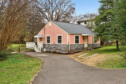 a view of a house with backyard porch and sitting area