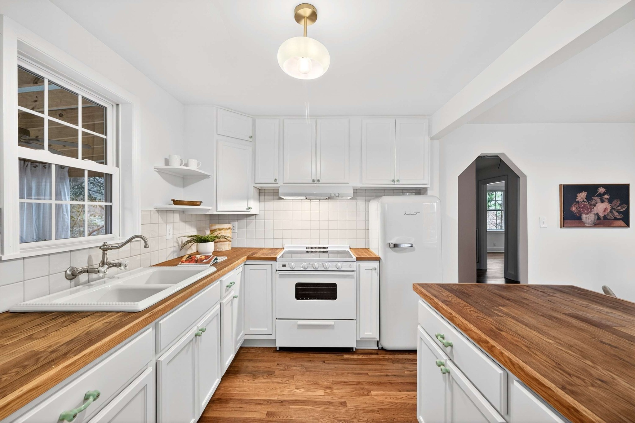 2017 Hackberry Lane Nashville, TN 37206 - Photo 12 of 36 a kitchen with a stove a sink and a refrigerator