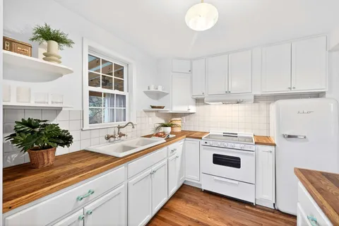 a kitchen with a sink and white cabinets