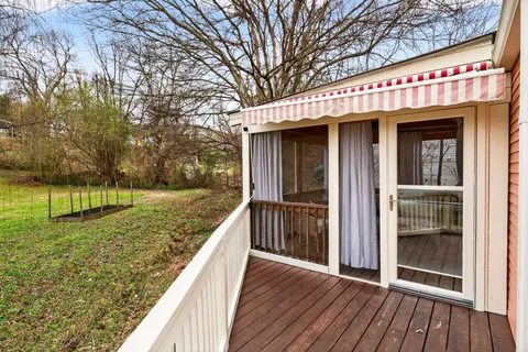 a view of a house with a wooden deck