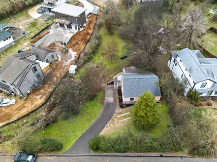 an aerial view of a house with a yard basket ball court and outdoor seating