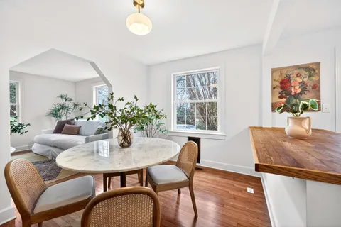 a dining room with furniture and wooden floor