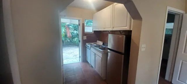 a kitchen with a refrigerator and a stove
