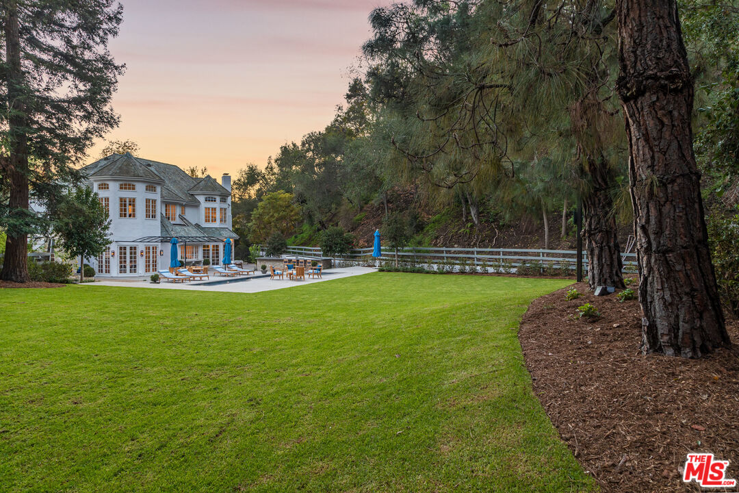 a view of a swimming pool and a yard