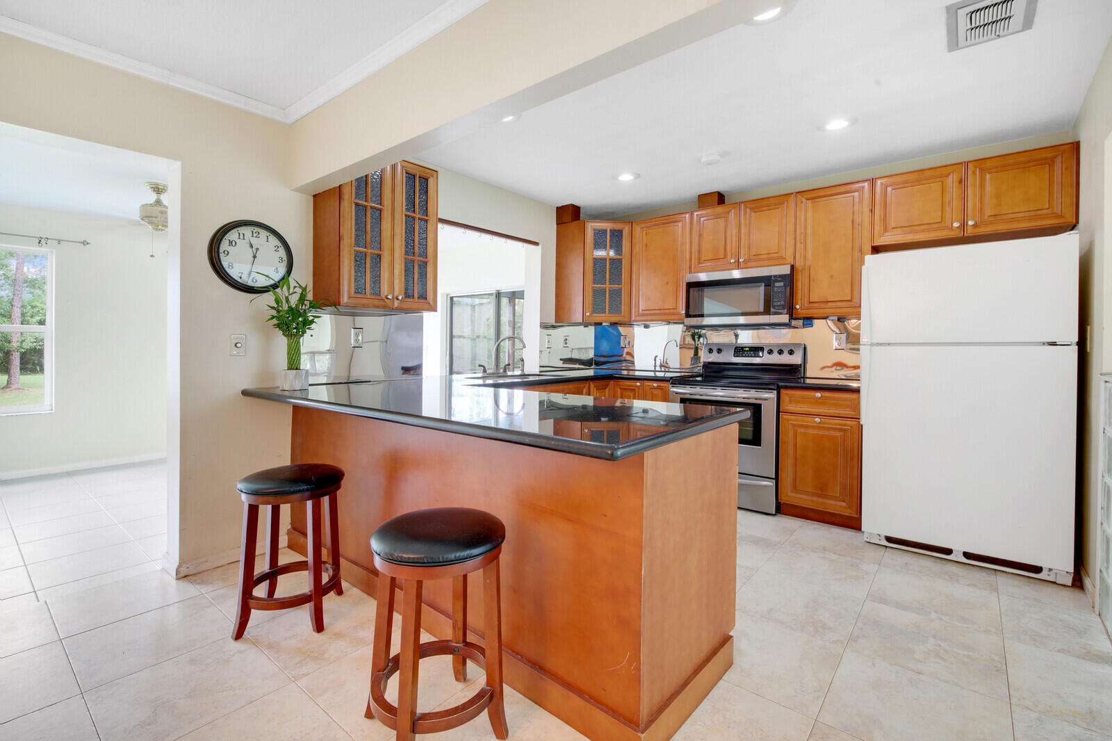 17575 Bridle Court Jupiter, FL 33478 - Photo 12 of 35 a kitchen with stainless steel appliances granite countertop a stove a sink a refrigerator and a refrigerator