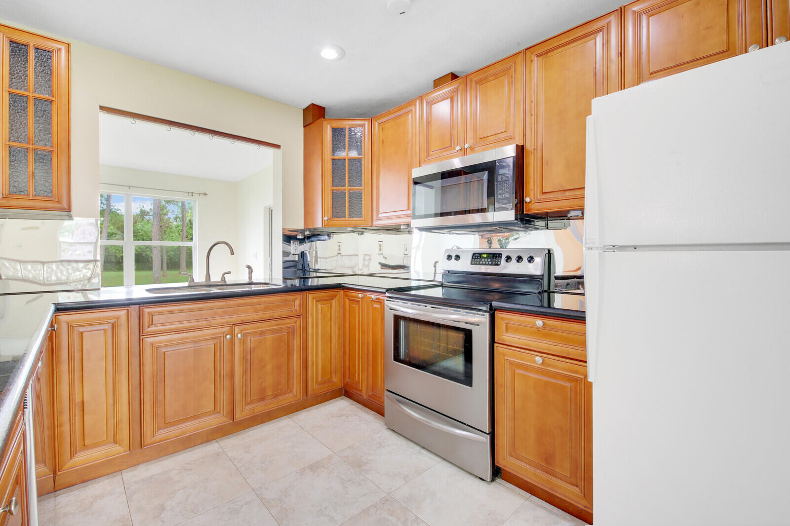 17575 Bridle Court Jupiter, FL 33478 - Photo 13 of 35 a kitchen with stainless steel appliances granite countertop a stove a sink and a refrigerator