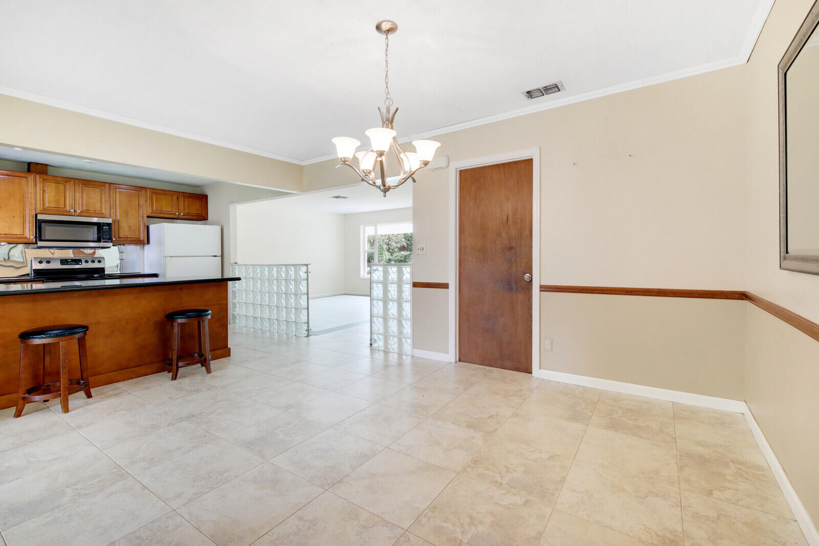 17575 Bridle Court Jupiter, FL 33478 - Photo 10 of 35 a view of a kitchen with a sink and a refrigerator