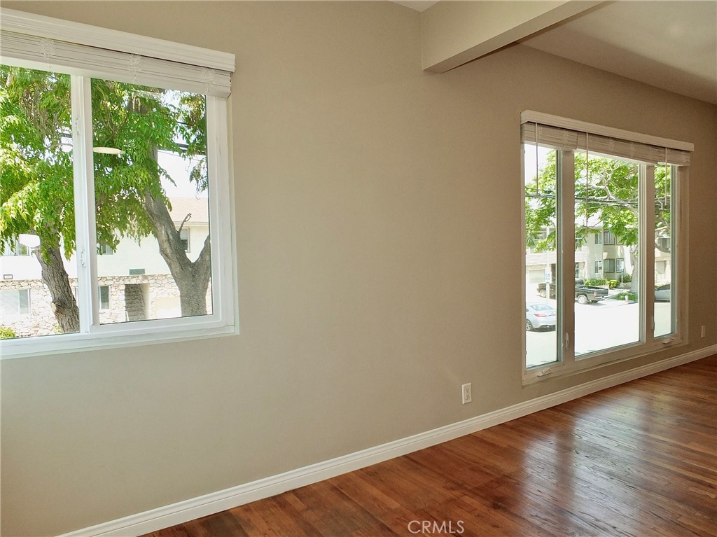 1808 East Appleton Street, Unit 7 Long Beach, CA 90802 - Photo 12 of 44 a view of an empty room with wooden floor and a window