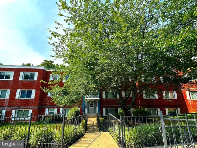 a front view of a brick house with a yard