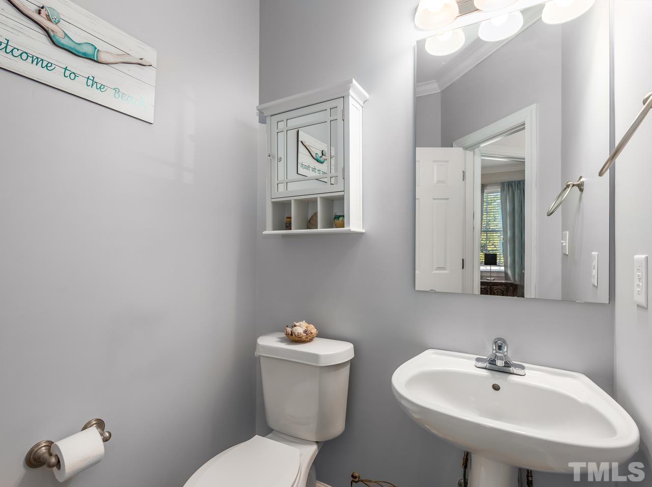 79 Kerrylane Drive Angier, NC 27501 - Photo 18 of 30 a bathroom with a toilet a sink and mirror