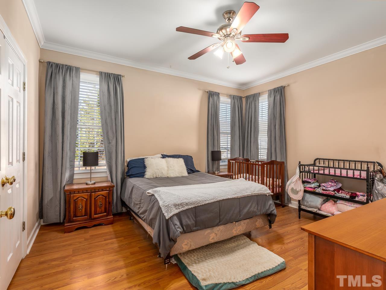 79 Kerrylane Drive Angier, NC 27501 - Photo 19 of 30 a bedroom with a bed and a chandelier