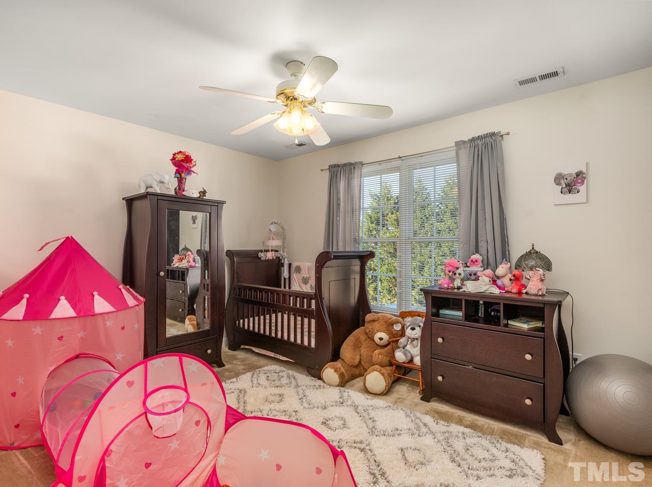 79 Kerrylane Drive Angier, NC 27501 - Photo 24 of 30 a bedroom with a bed and a chandelier