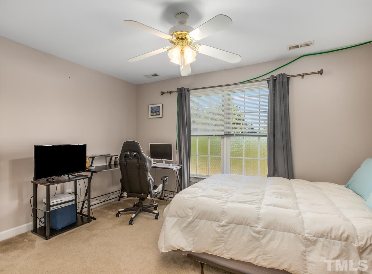 79 Kerrylane Drive Angier, NC 27501 - Photo 26 of 30 a bedroom with a bed tv and a window