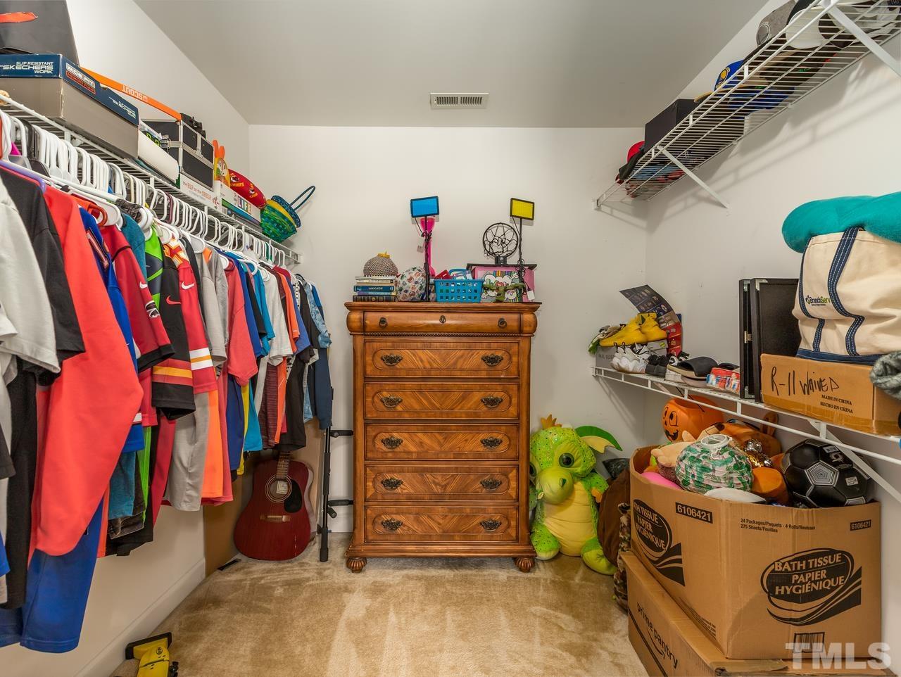 79 Kerrylane Drive Angier, NC 27501 - Photo 27 of 30 a view of walk in closet with clothes and shoes