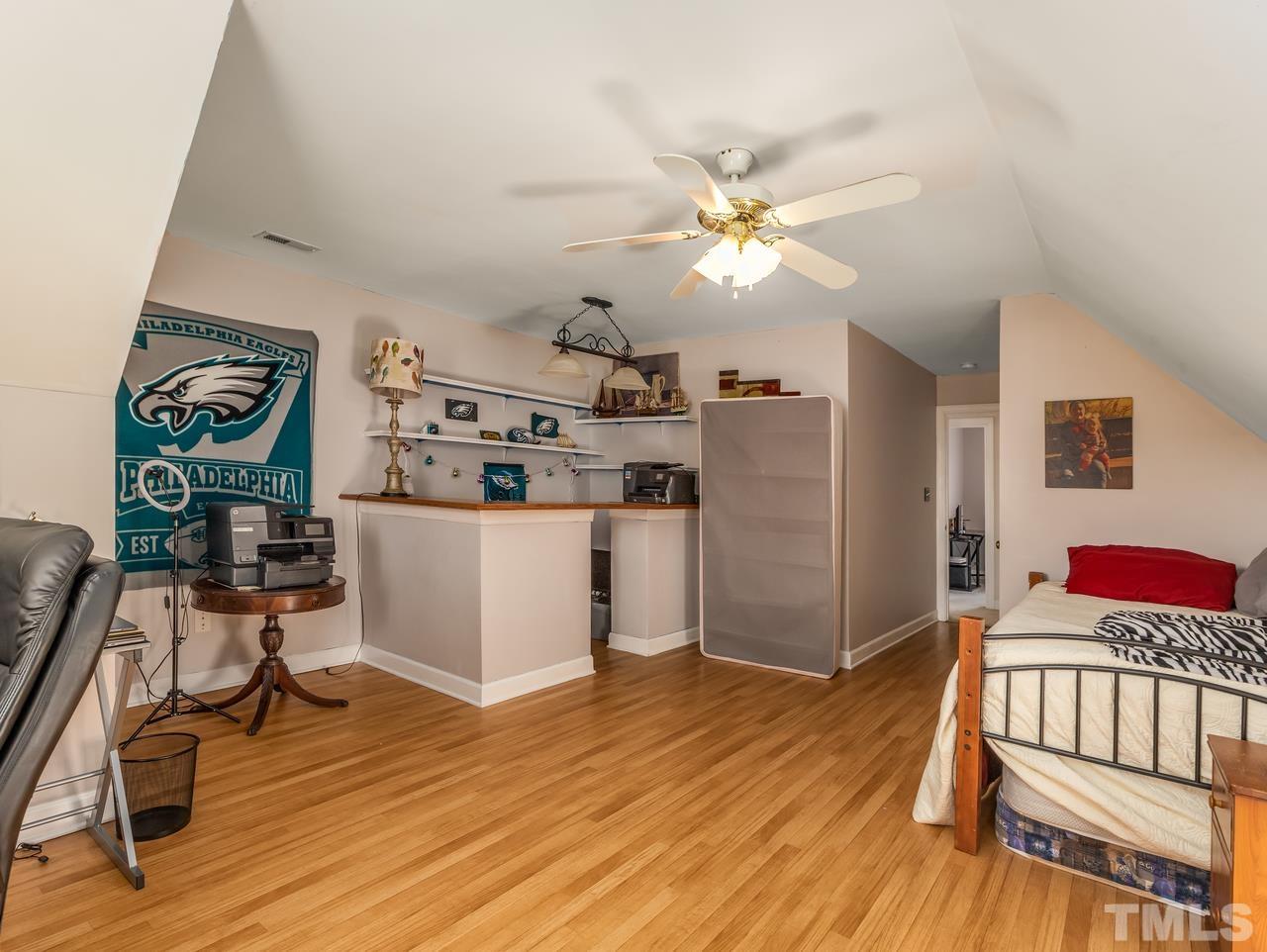 79 Kerrylane Drive Angier, NC 27501 - Photo 29 of 30 a living room with kitchen island stainless steel appliances furniture and a wooden floor