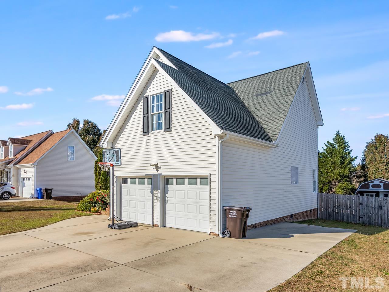 79 Kerrylane Drive Angier, NC 27501 - Photo 4 of 30 a view of a house with backyard and trees