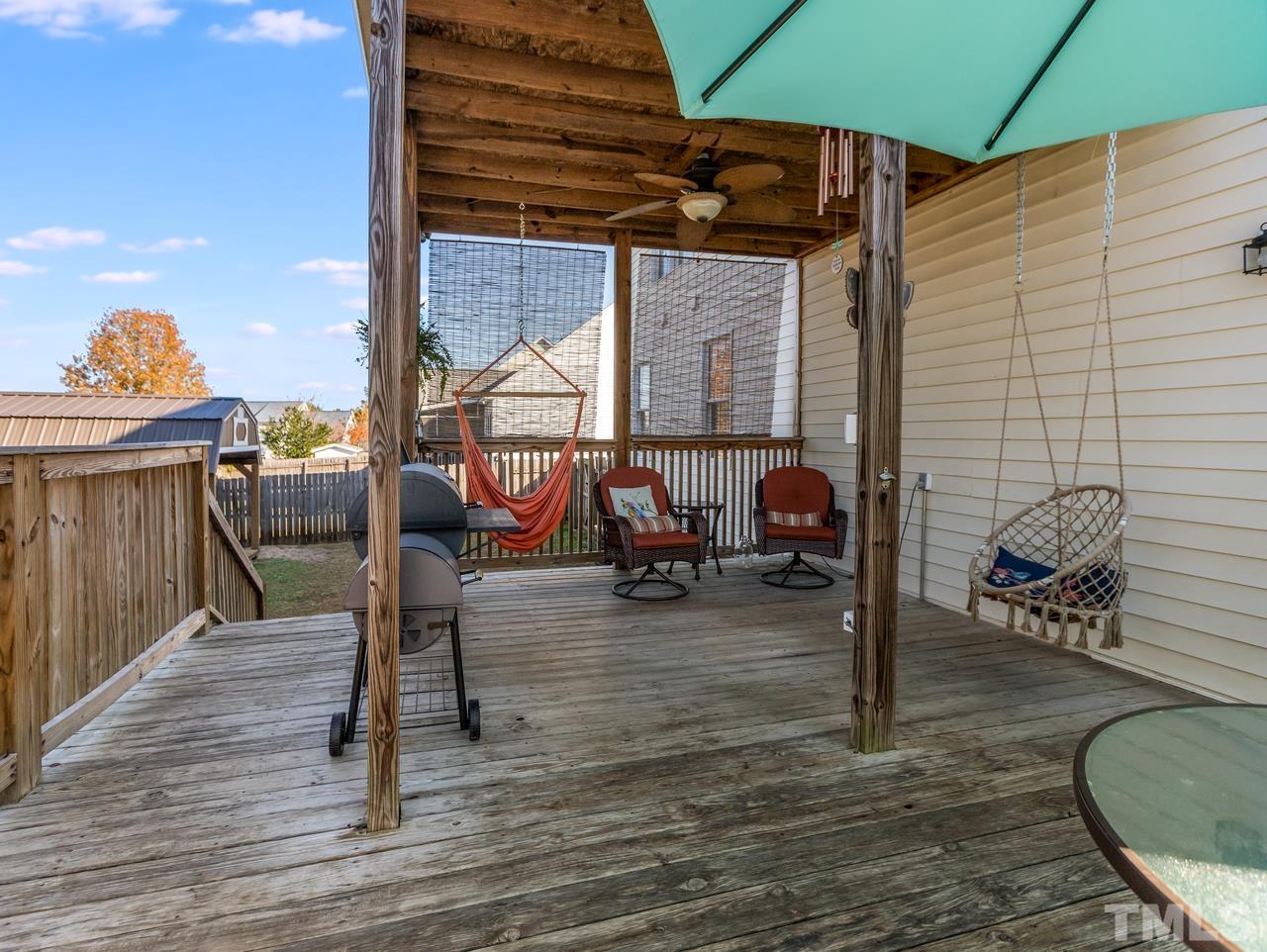 79 Kerrylane Drive Angier, NC 27501 - Photo 9 of 30 a view of a patio with a table and chairs under an umbrella