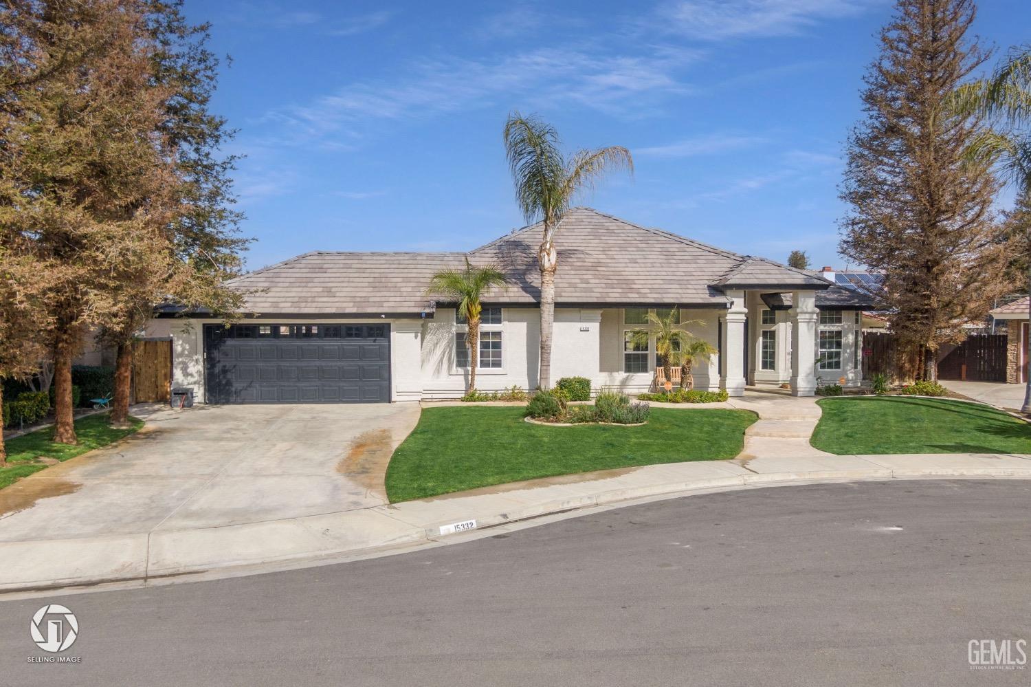 Undisclosed Address Bakersfield, CA 93314 - Photo 1 of 45 front view of a house with a yard and an trees