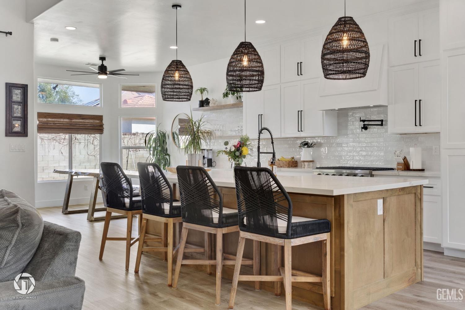 Undisclosed Address Bakersfield, CA 93314 - Photo 17 of 45 a kitchen with stainless steel appliances granite countertop a stove a kitchen island a dining table and chairs